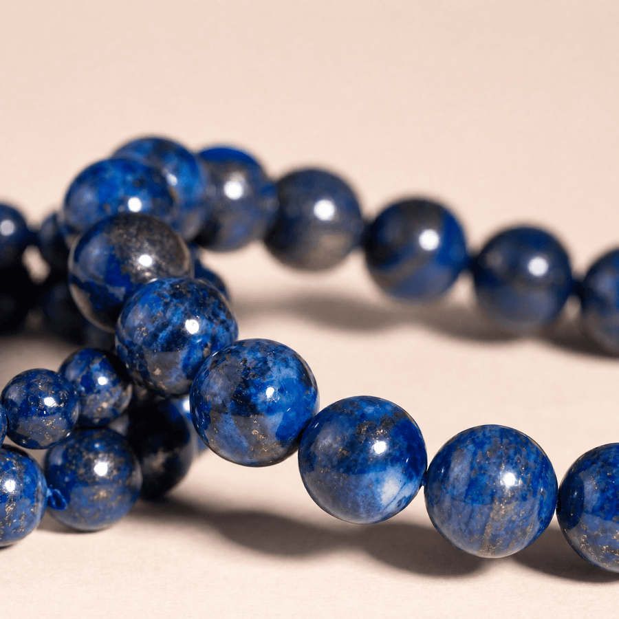 Close-up of royal-blue Lapis Lazuli beads with golden pyrite flecks and natural gray matrix