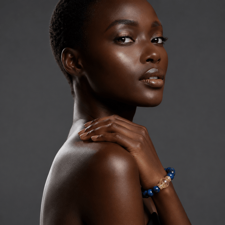 Lapis Lazuli and Citrine bracelet worn in a dark-gray editorial portrait