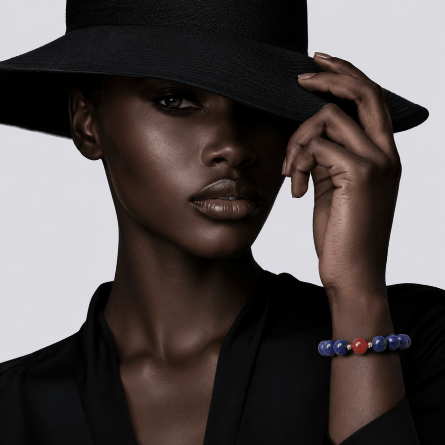 Model wearing Lapis Lazuli bracelet with red Nanhong Agate accent and gold-tone spacers
