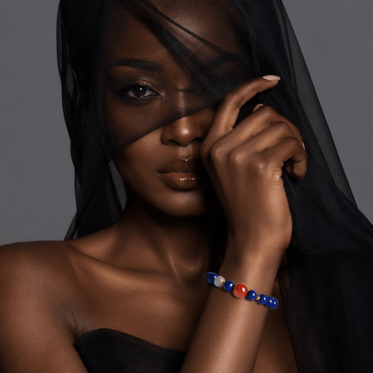 Lapis Lazuli bracelet with Nanhong focal bead shown on model in black styling