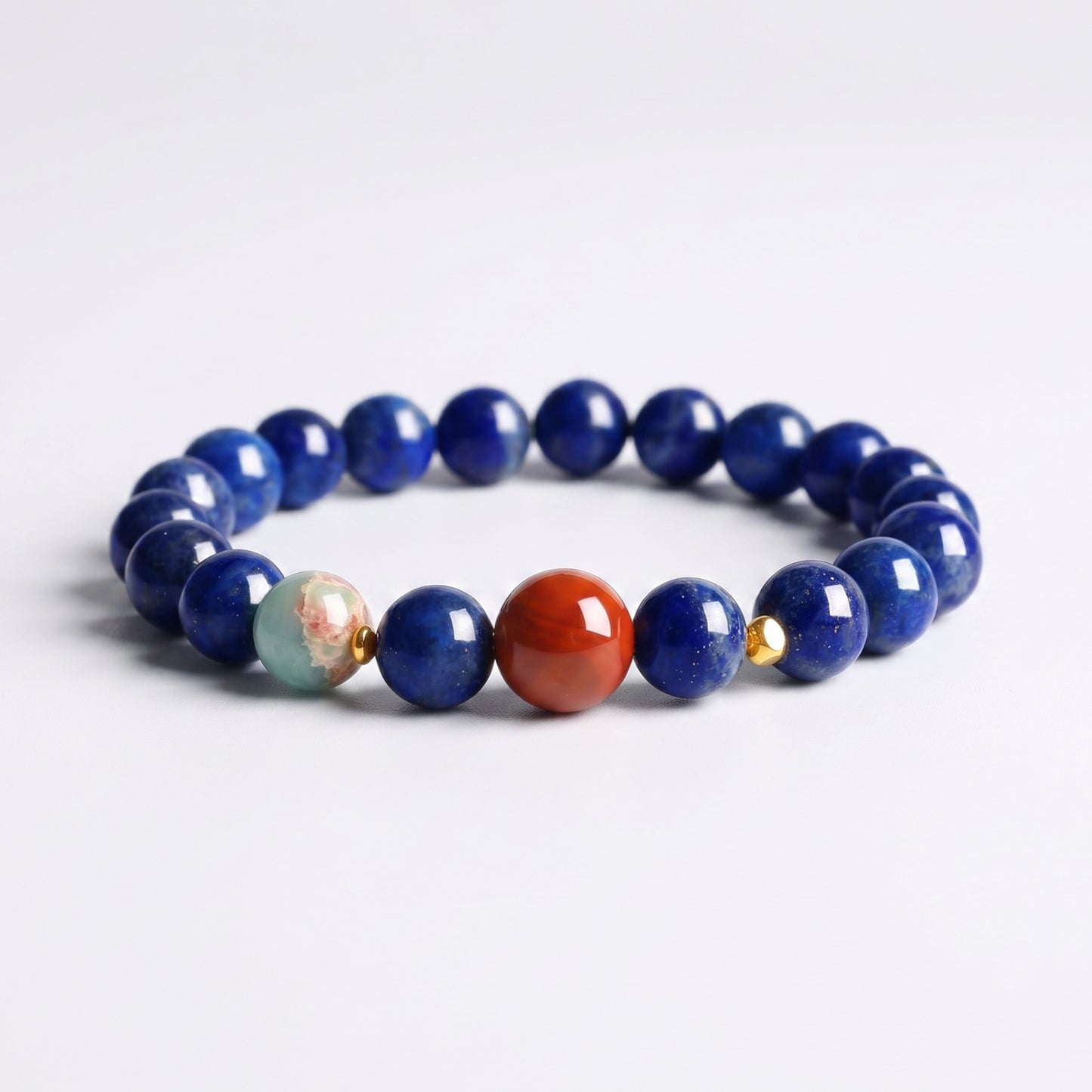 Natural Lapis Lazuli bracelet with Nanhong Agate focal bead, decorative accent bead and gold-tone details