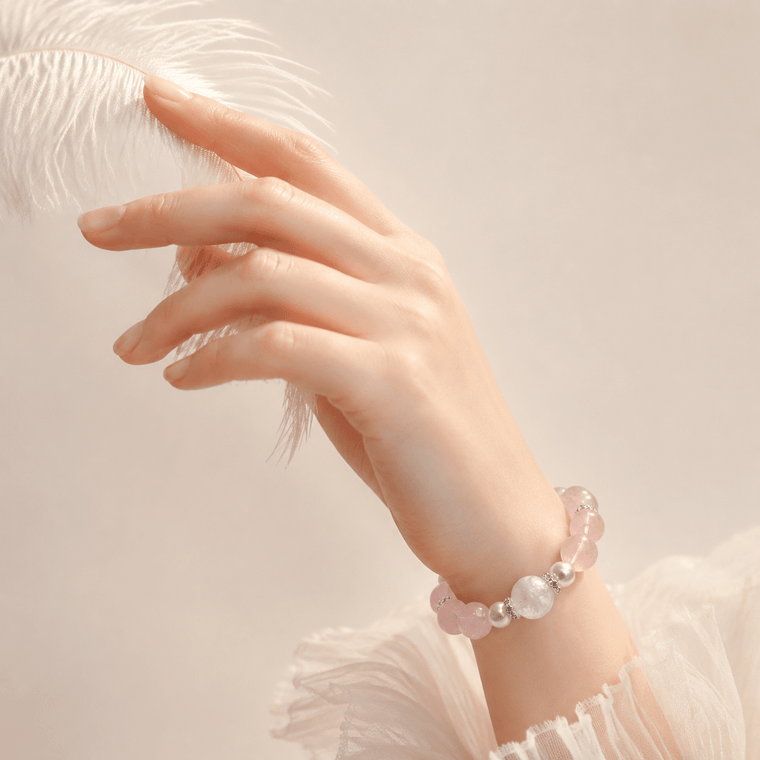 Woman wearing Love Lives Here Rose Quartz bracelet with Snowflake Phantom centerpiece and white feather