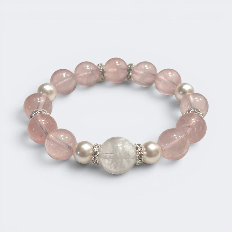 Front view of Love Lives Here bracelet with 10mm natural Rose Quartz beads and Snowflake Phantom centerpiece