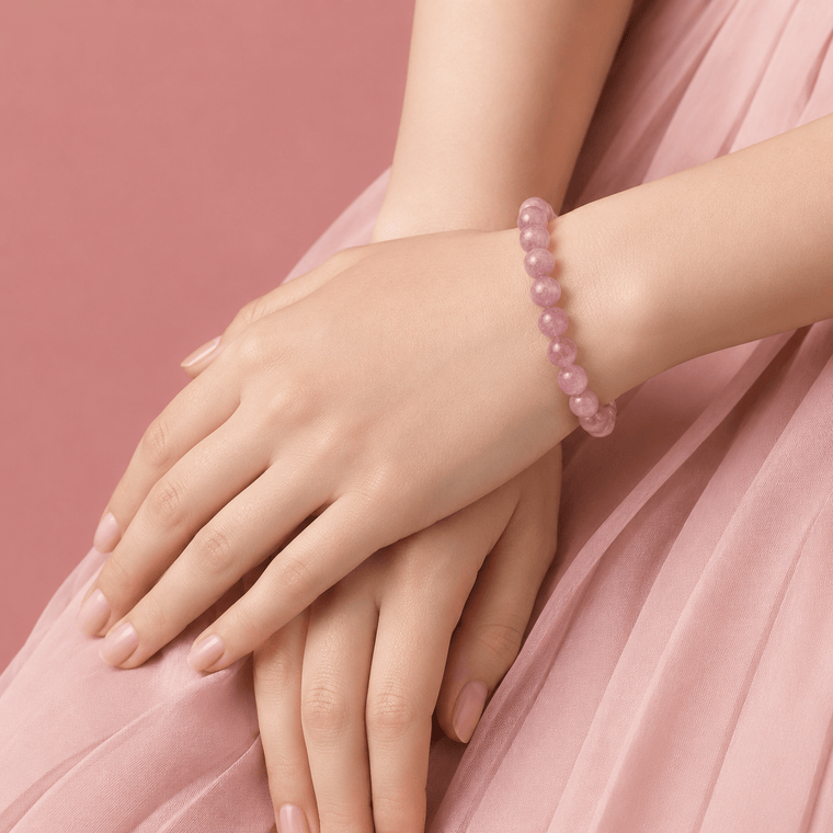 Woman wearing Loved As I Am Rose Quartz bracelet with a soft pink dress