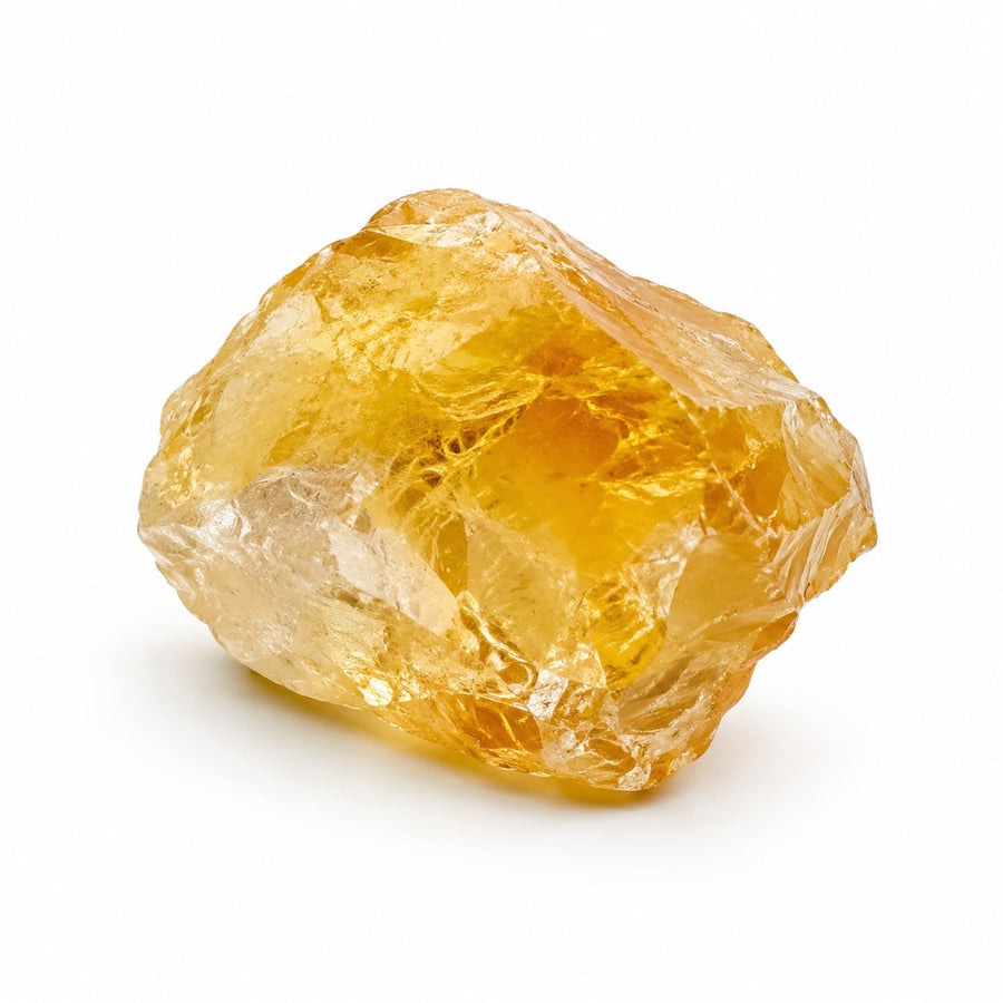 Raw golden citrine crystal on a white background