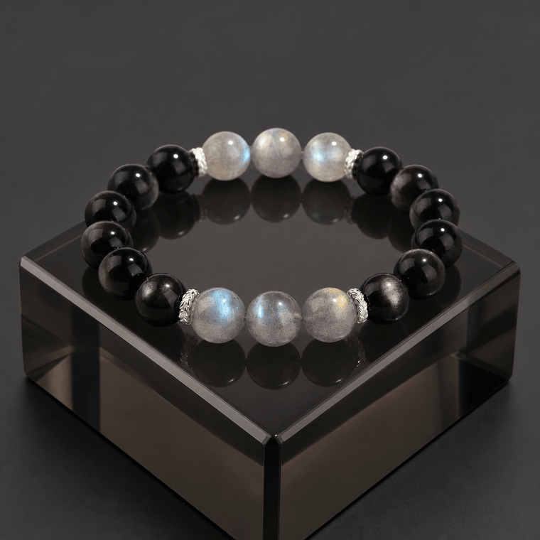 My Energy Is Mine Obsidian and Gray Moonstone bracelet displayed on glossy black acrylic stand