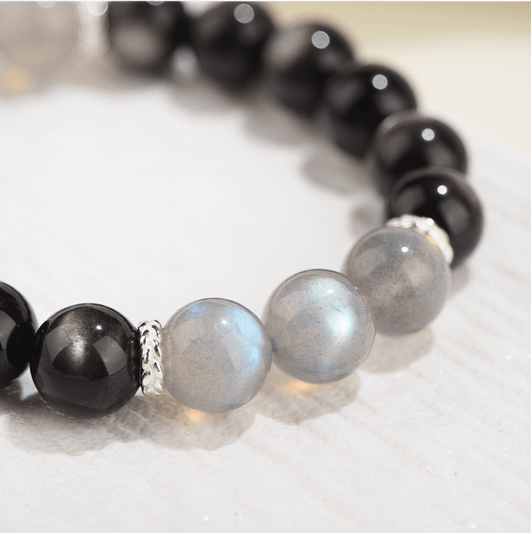 Close-up of Gray Moonstone accent beads with blue flash on My Energy Is Mine Obsidian bracelet