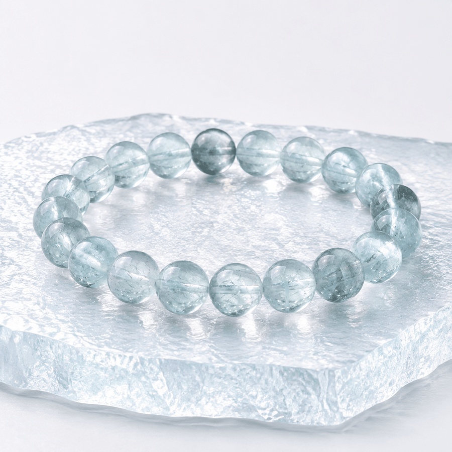 Natural Green Fluorite bracelet displayed on a clear ice-textured block
