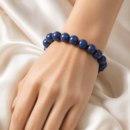 Natural Lapis Lazuli bracelet worn against soft ivory satin fabric