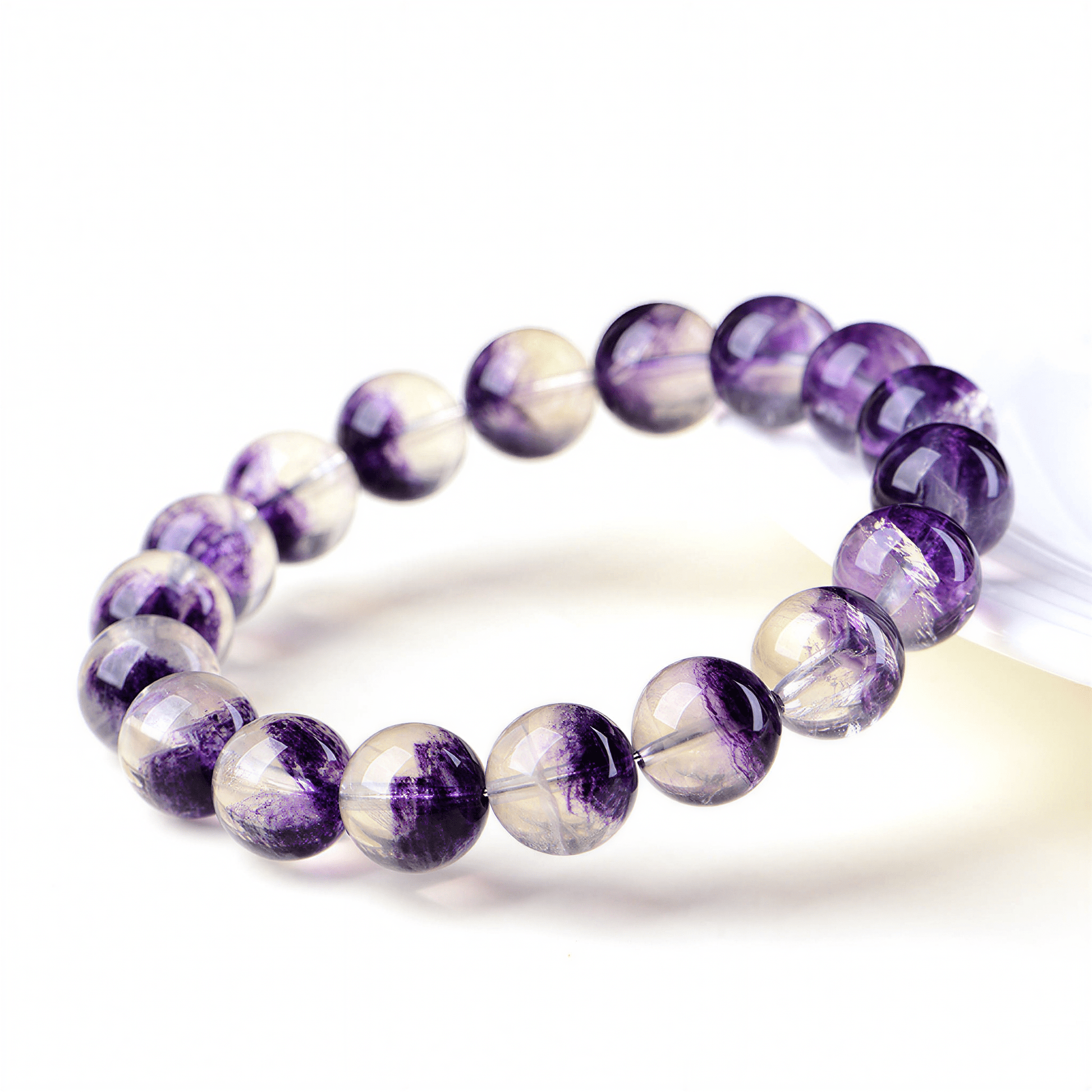 Close-up of transparent Purple Fluorite beads with deep violet natural color zoning