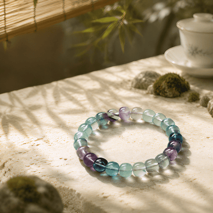 Multicolor Fluorite bracelet displayed in a warm tea and bamboo setting