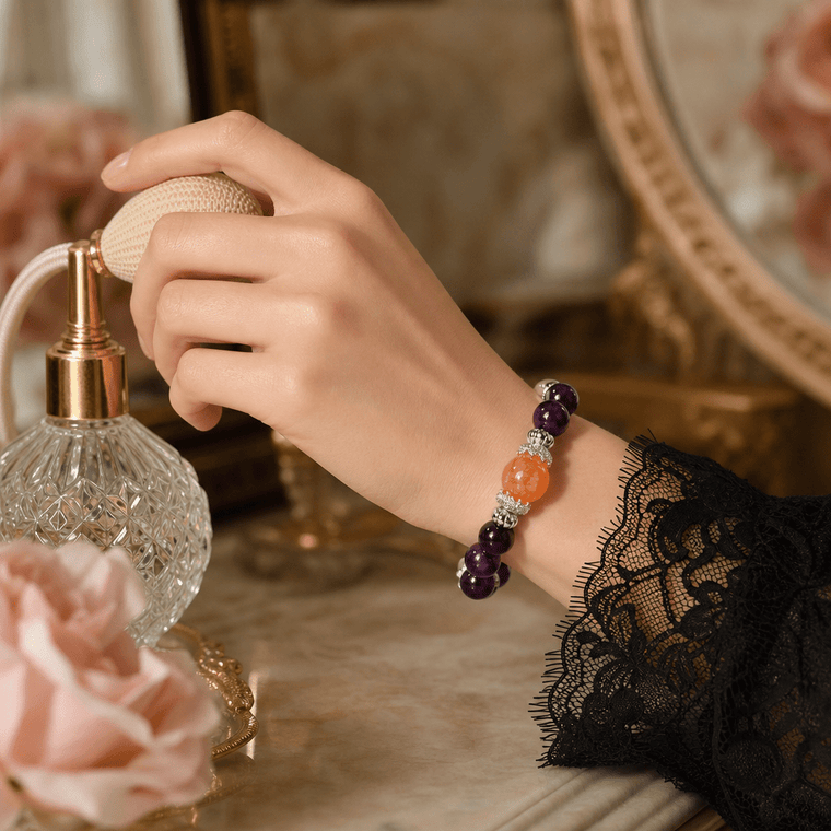 Woman wearing The Courage to Bloom Amethyst bracelet in a vintage vanity setting