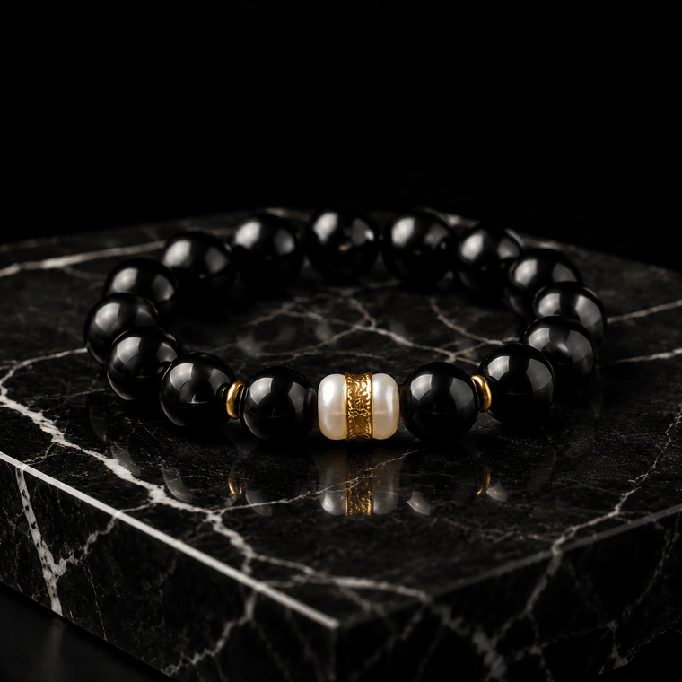 The Way Opens Obsidian mantra bracelet displayed on black marble with gold-tone and white centerpiece