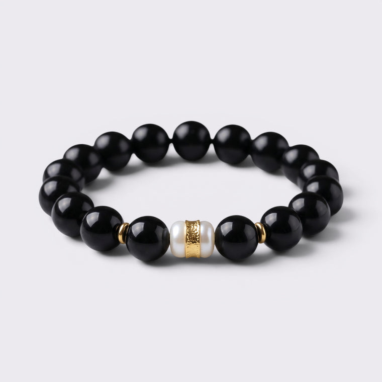 Front view of The Way Opens bracelet with 12mm natural Obsidian beads and Six-Syllable Mantra turning bead centerpiece