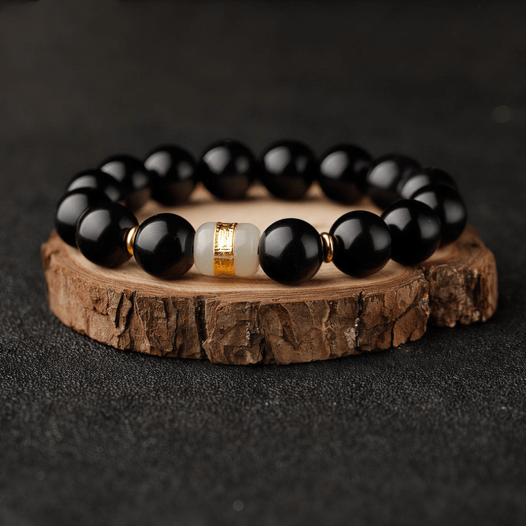The Way Opens Obsidian bracelet displayed on wood slice with Six-Syllable Mantra turning bead